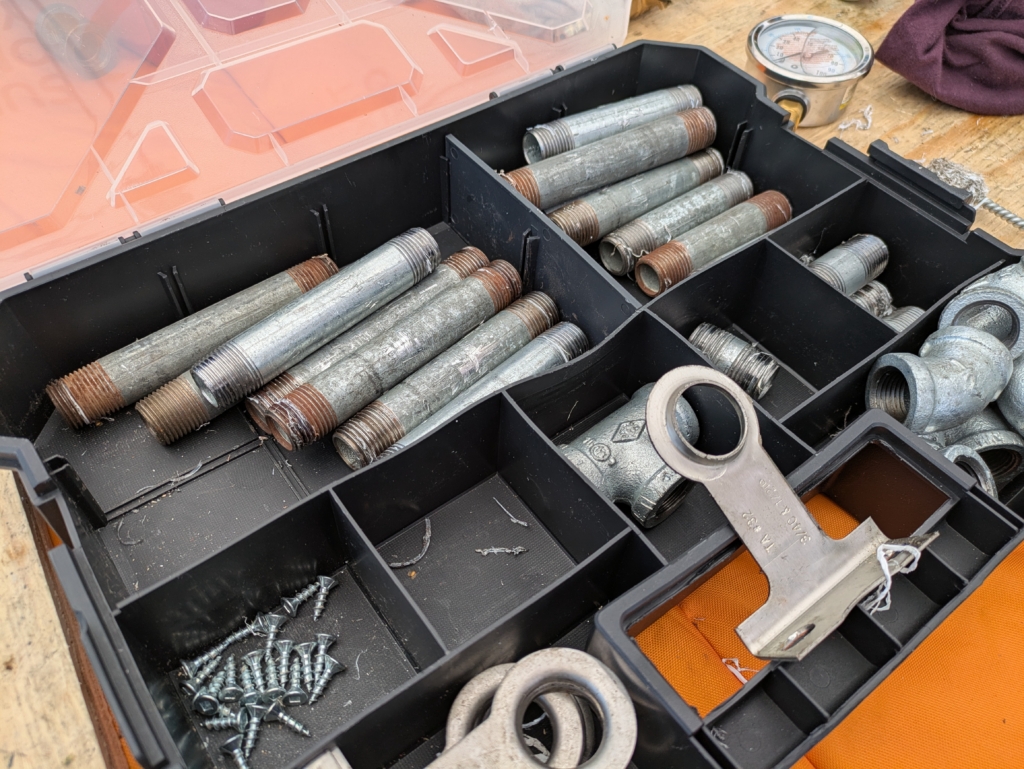 A plastic organizer container with various galvanized steel parts