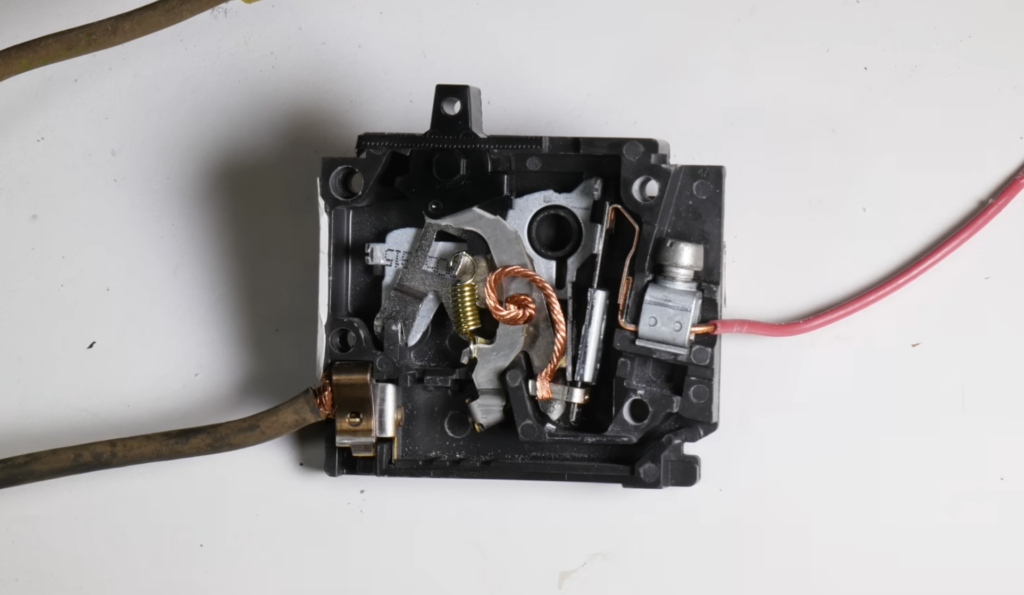 Split view of a circuit breaker in the tripped state