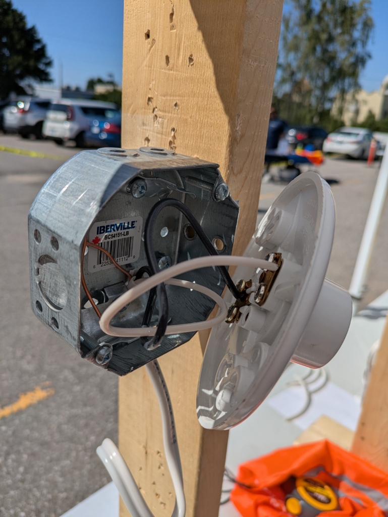 Octagonal box with light fixture and neutral, hot and ground wires connected