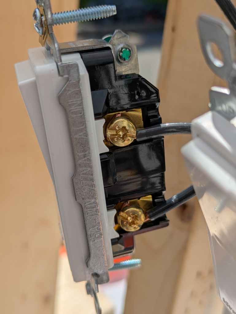 Light switch with black wires on the brass screws