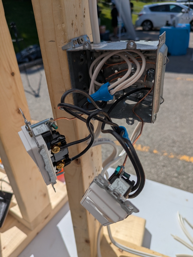 Two light switches connected to the power source using pigtails